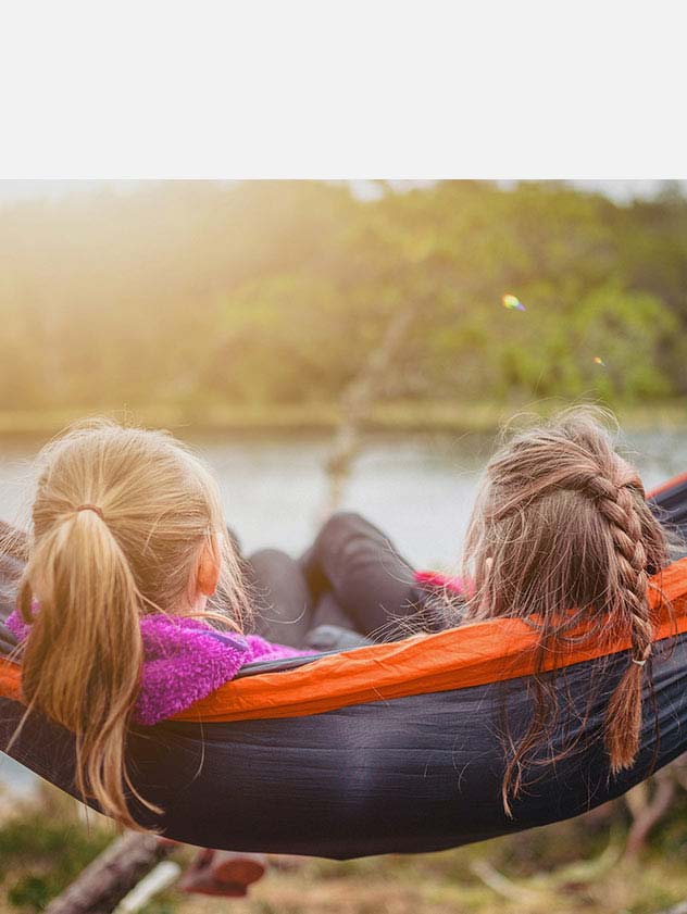 Two girls sitting on a hammock