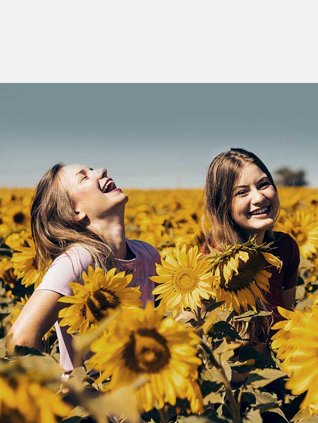 Two girls in a sunflower field
