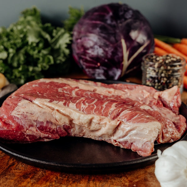 raw beef brisket point on skillet