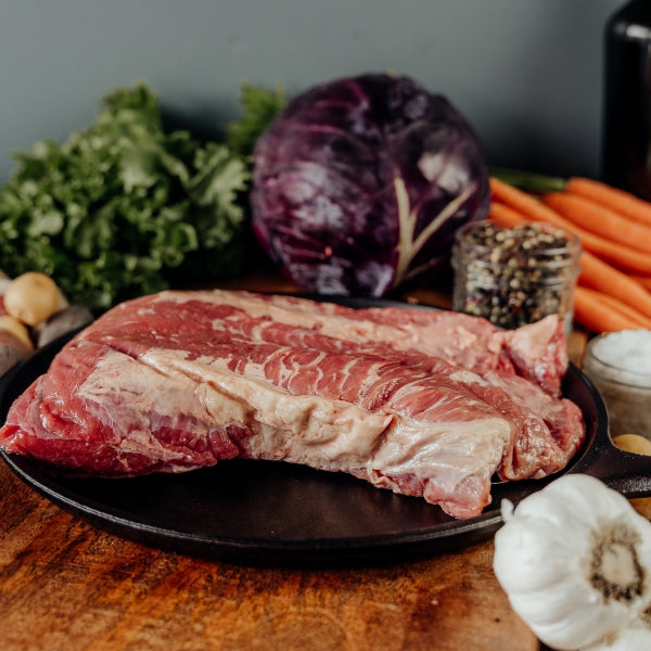 raw beef brisket point on skillet