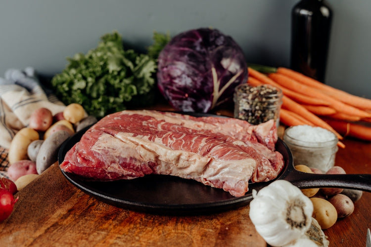 raw beef brisket point on skillet