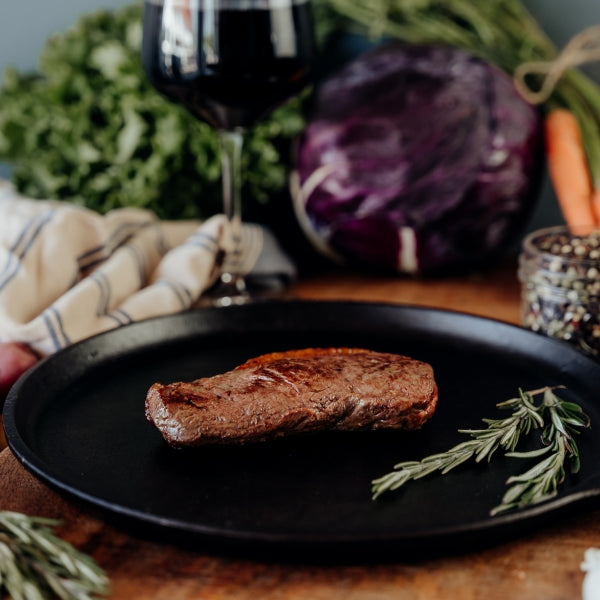 grilled beef coulotte steak on skillet