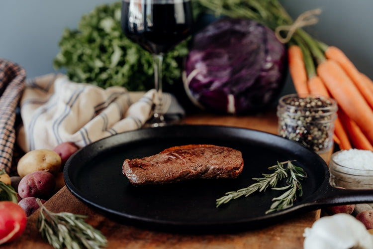 grilled beef coulotte steak on skillet