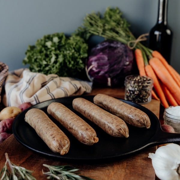 beef italian sausage links uncooked on skillet