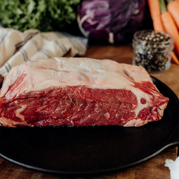 raw beef loin roast on skillet