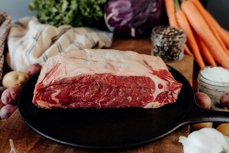 raw beef loin roast on skillet