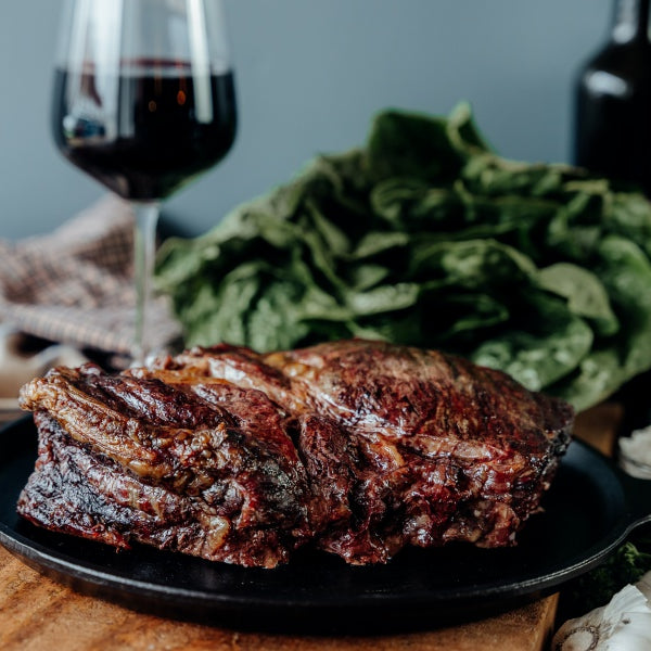 slow cooked grassfed beef chuck roast on table with wine