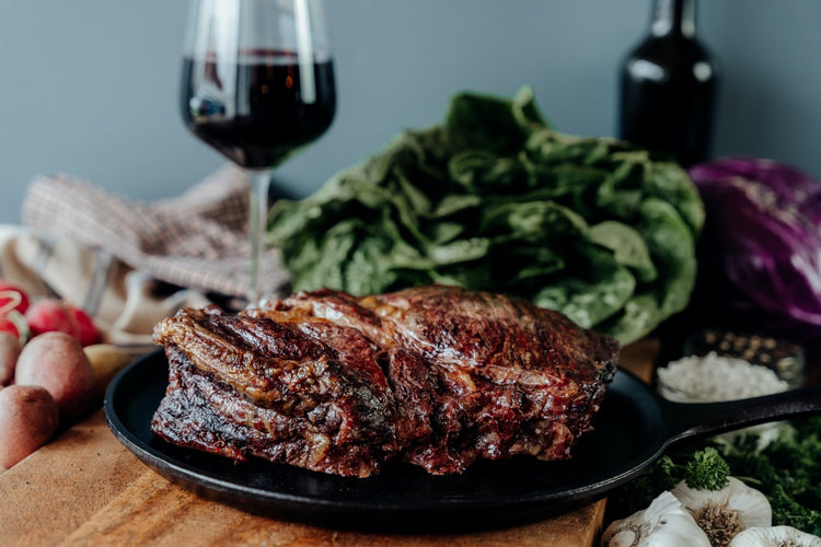 slow cooked grassfed beef chuck roast on table with wine