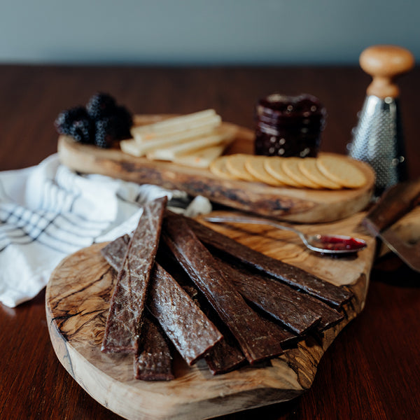 Grassfed Beef Jerky Sticks PLAIN on wood board