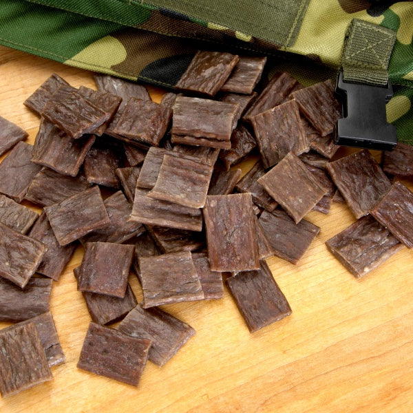 spicy jerky sticks cut in pieces wih camo knife holster