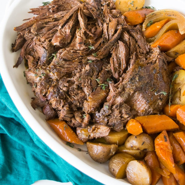 grassfed beef center cut shoulder roast slow cooked with carrots and potatoes