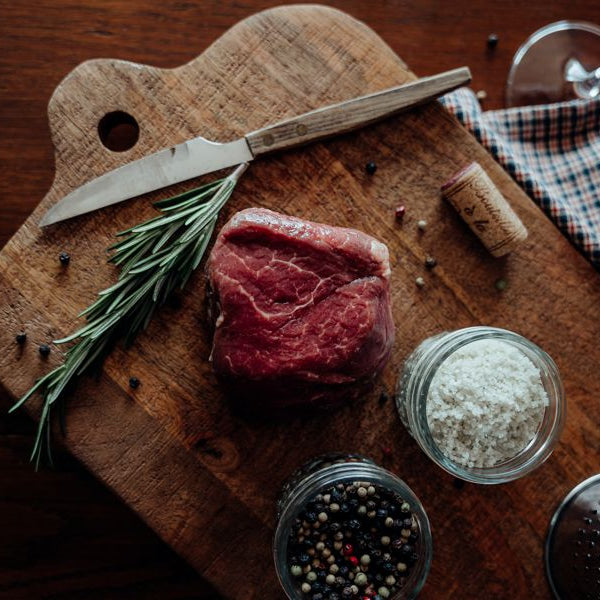 Grassfed Beef Tenderloin Filet Mignon on board with salt, pepper