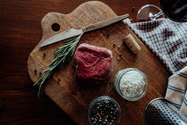 Grassfed Beef Tenderloin Filet Mignon on board with salt, pepper