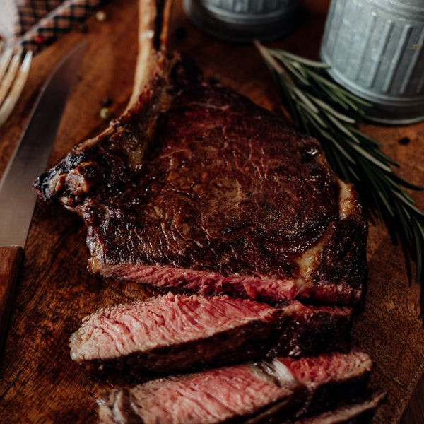 Grilled and sliced Grassfed Tomahawk Steak, French Cut Ribeye, cowboy cut