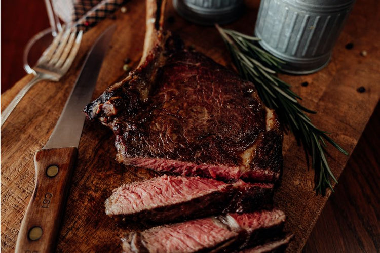 Grilled and sliced Grassfed Tomahawk Steak, French Cut Ribeye, cowboy cut