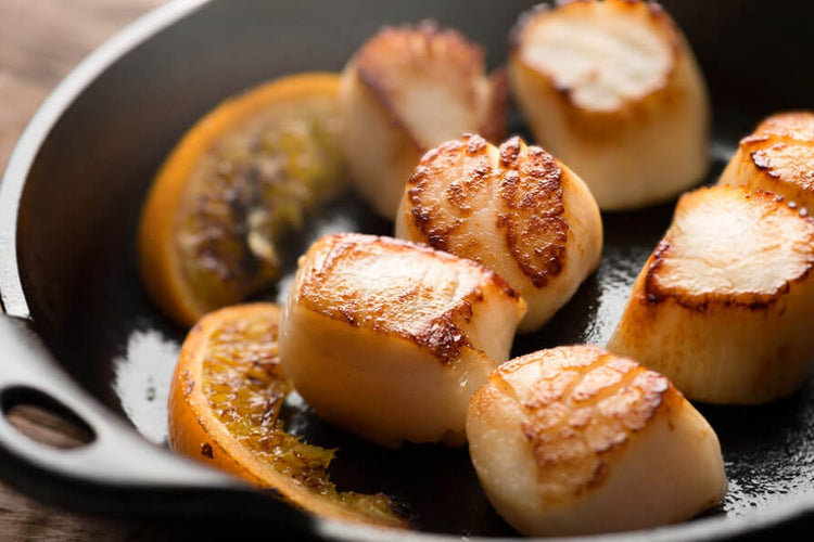 fresh alaskan weathervane scallops grilled with lemons