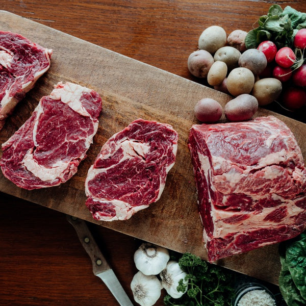 overhead view whole grassfed ribeye primal cut into steaks