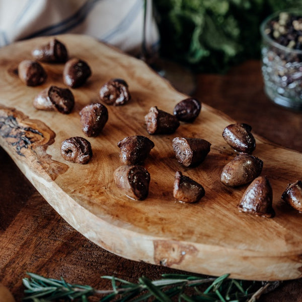 Cooked pasture-raised chicken hearts on board