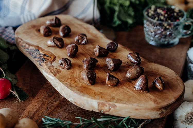 Cooked pasture-raised chicken hearts on board