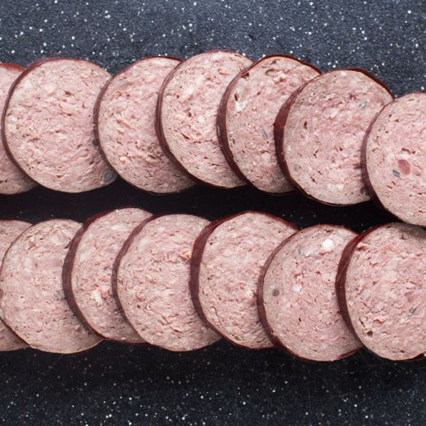 Grassfed Beef Head Cheese Sliced on cutting board