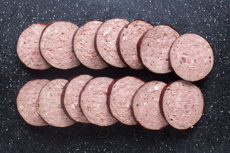 Grassfed Beef Head Cheese Sliced on cutting board