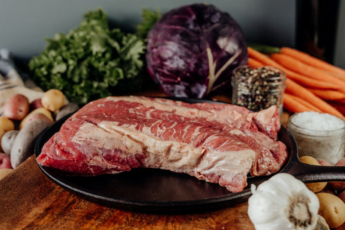 raw beef brisket point on skillet