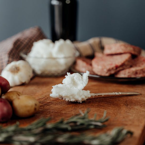 Premium beef tallow, spoon with tallow on cutting board