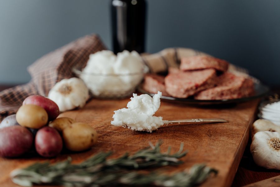 Premium beef tallow, spoon with tallow on cutting board