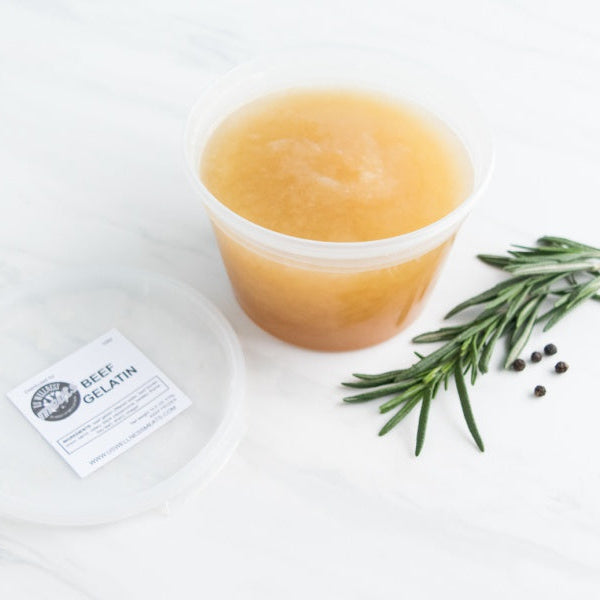 all natural grassfed beef gelatin in container with rosemary sprig