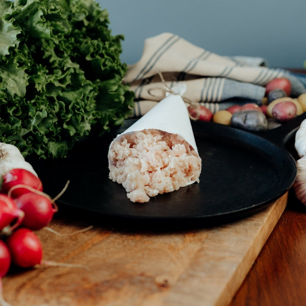 raw ground rabbit in a butcher paper cone