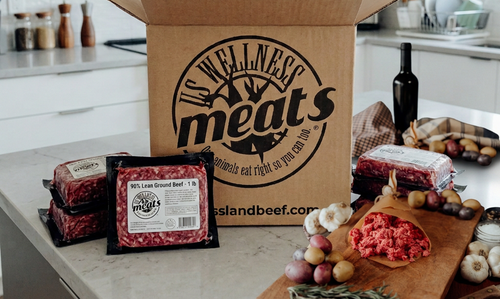 90% Lean Ground Beef individual packages on a kitchen counter with US Wellness Meats box