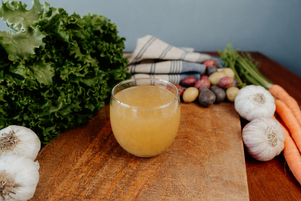 chicken gelatin in a glass on wooden cutting board