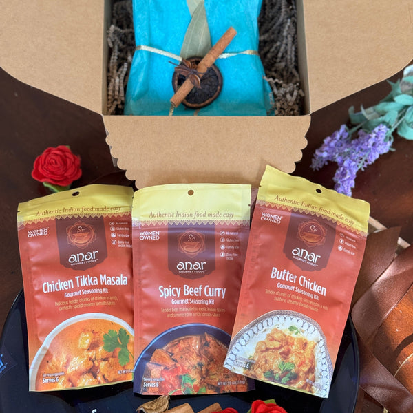 Three anar brand seasoning kits for chicken, beef, and butter chicken in a box with decorative elements.