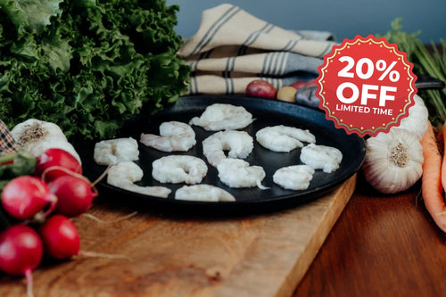 Shrimp on a pan with vegetables and a promotional offer sign.