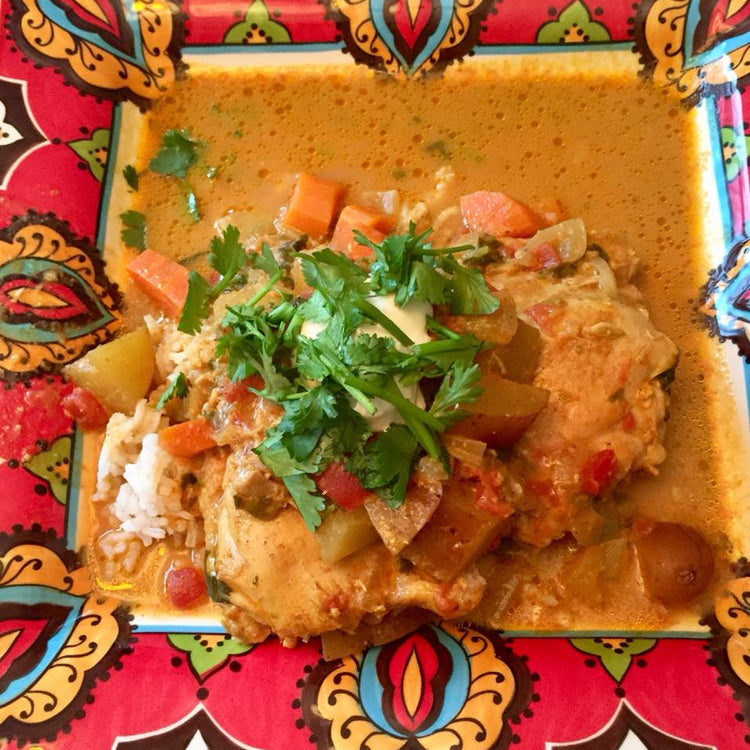 Colorful dish with chicken and vegetables on a decorative plate