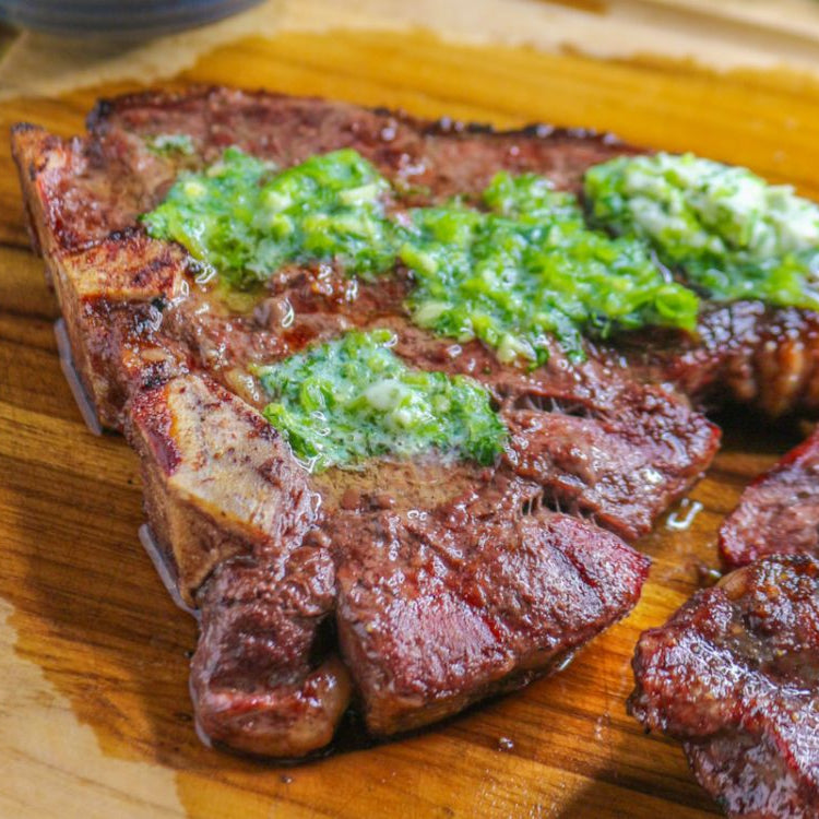 T-bone steak on cutting board with jalapeno butter