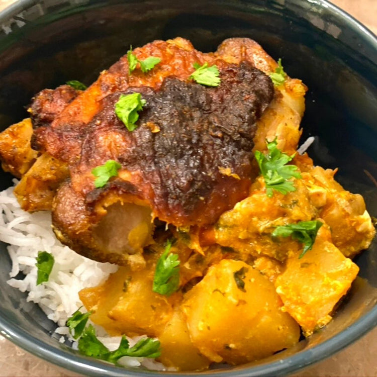 Bowl of chicken and potato curry with rice