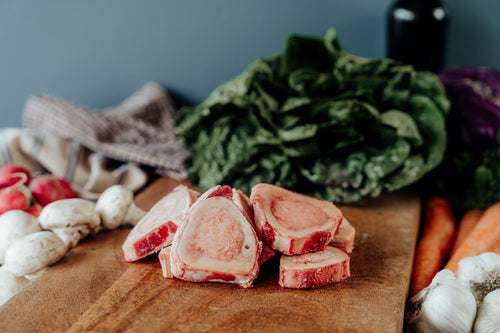 grassfed beef thin cut marrow bones on cutting board