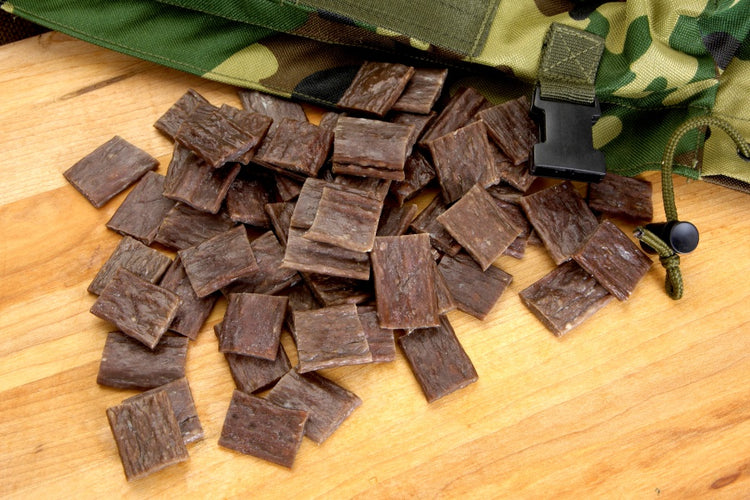 spicy jerky sticks cut in pieces wih camo knife holster