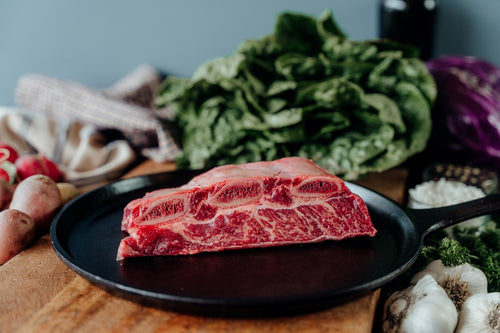 grassfed beef bone-in short ribs on skillet